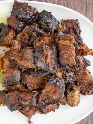 smoked beef brisket burnt ends on a white platter.