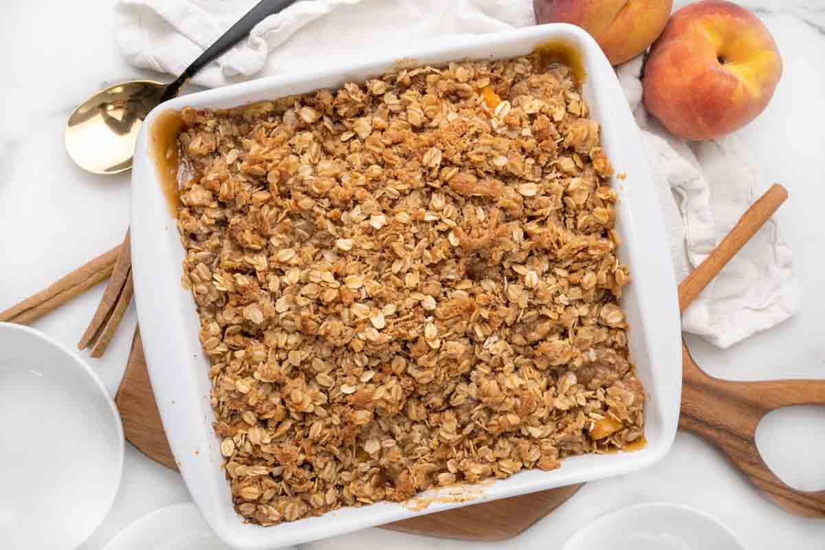 White baking dish with fully baked peach crisp.