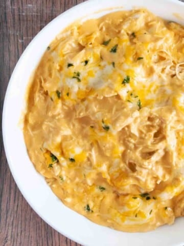 Slow cooker Buffalo chicken Dip in a white bowl.
