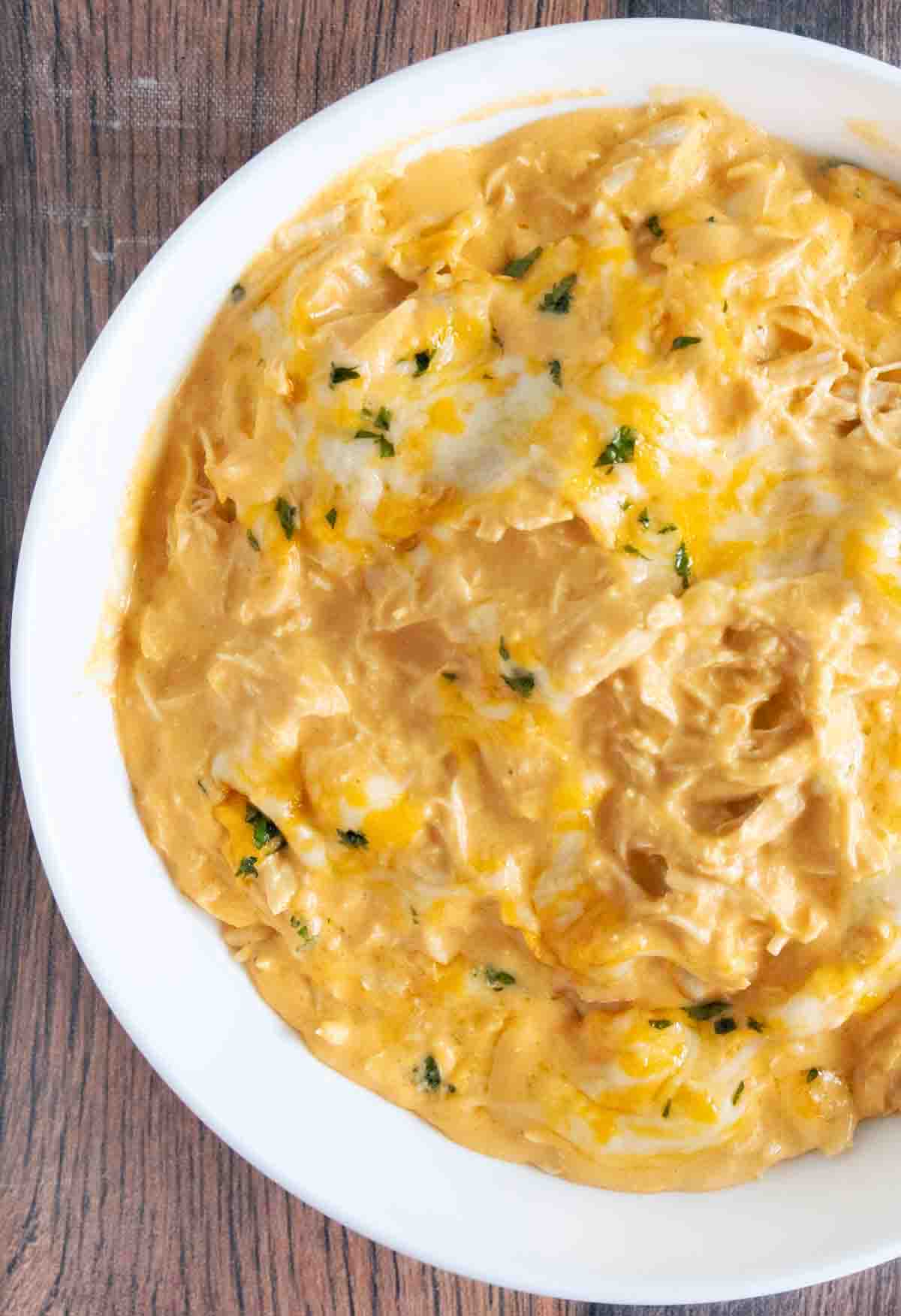 Slow cooker Buffalo chicken Dip in a white bowl.