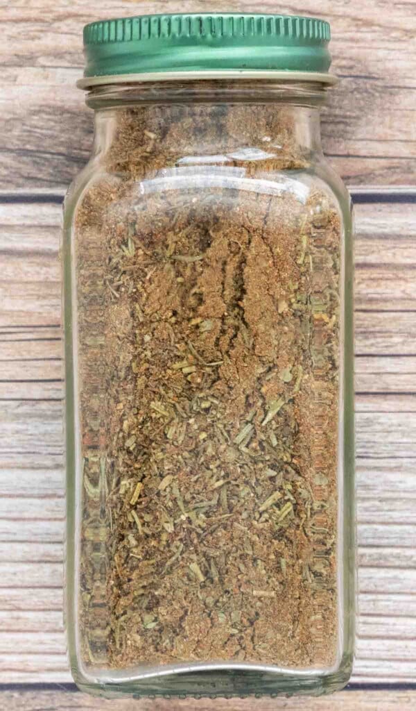 Poultry seasoning in a glass jar with a green lid.