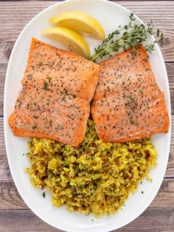 baked salmon and rice on a white platter