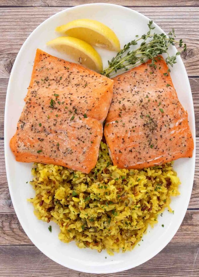 baked salmon and rice on a white platter