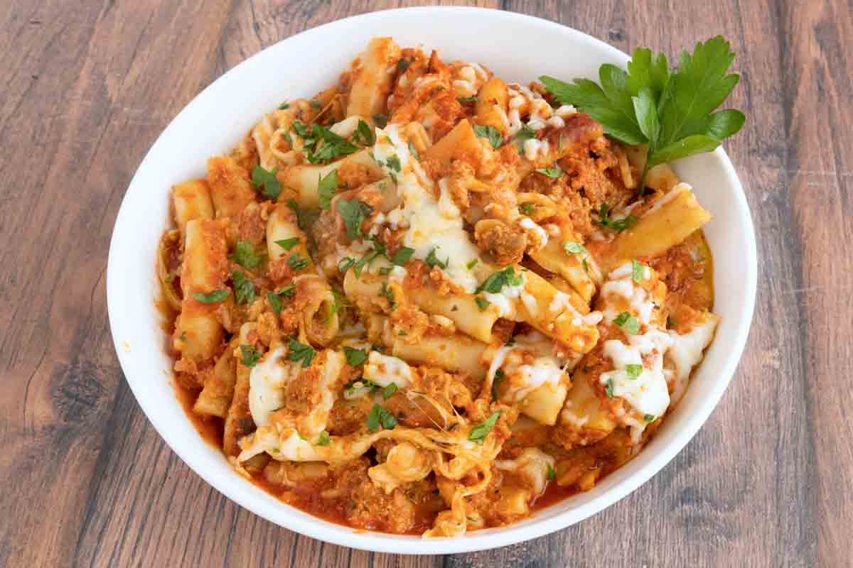 Baked ziti in a white bowl.