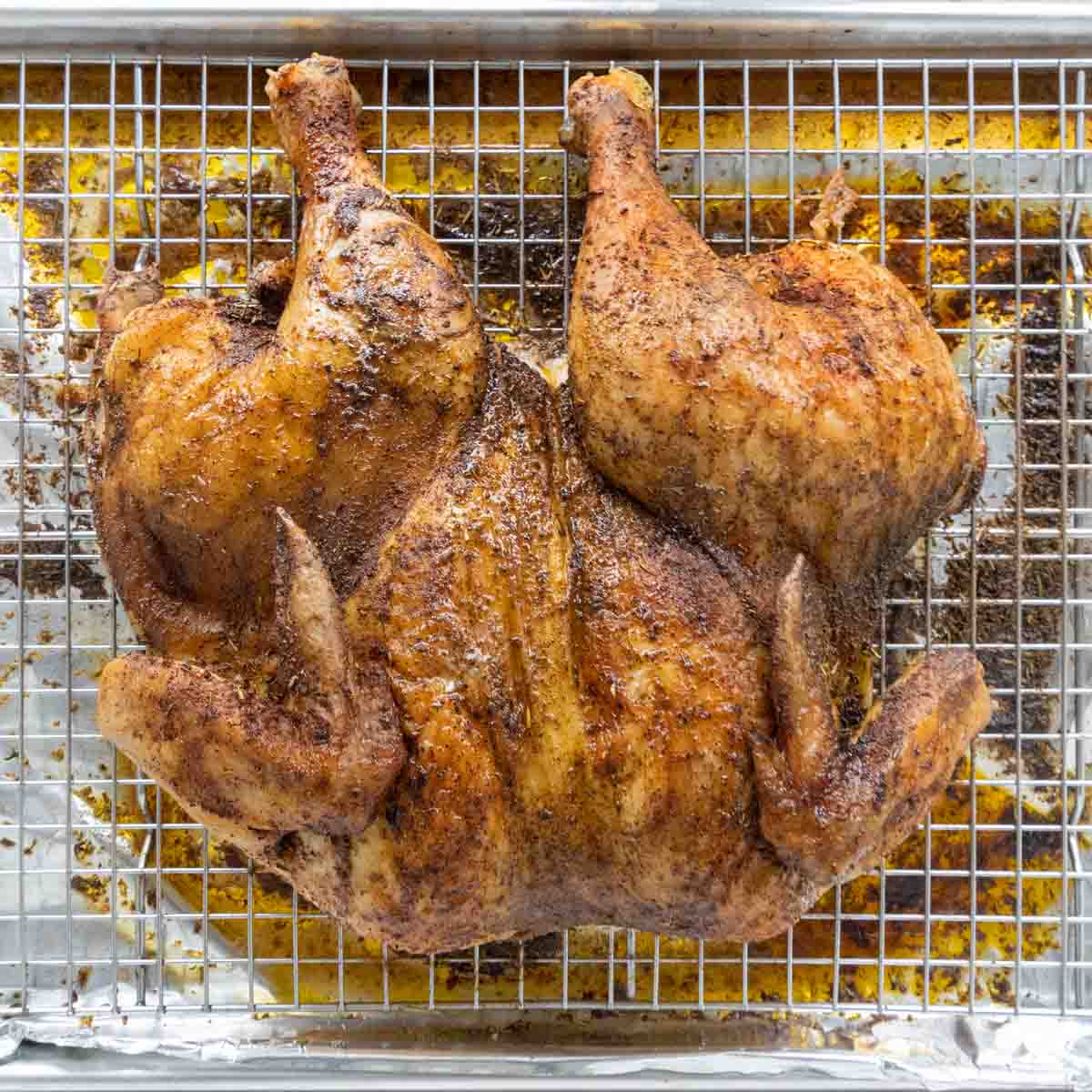 roasted spatchcock chicken on wire rack.