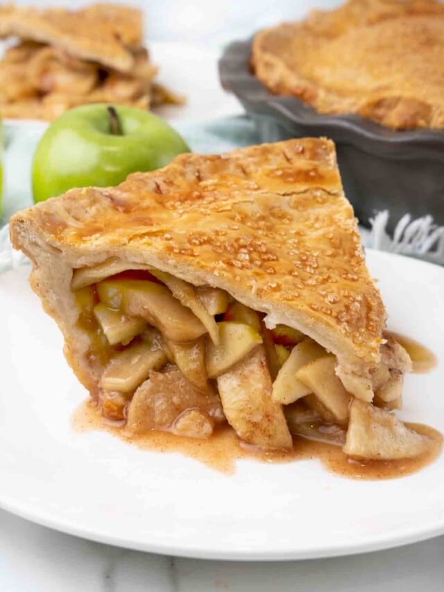 Slice of apple pie on a white plate.