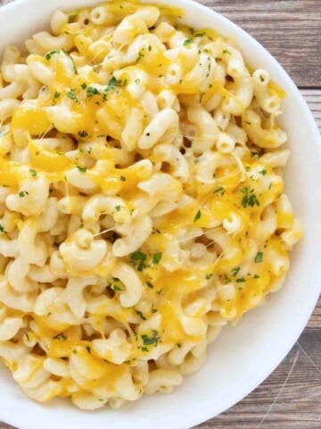slow cooker mac and cheese in a white bowl.