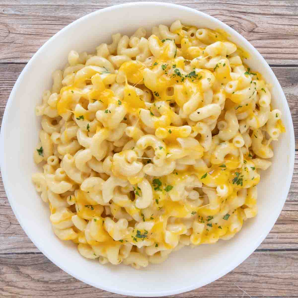 slow cooker mac and cheese in a white bowl.