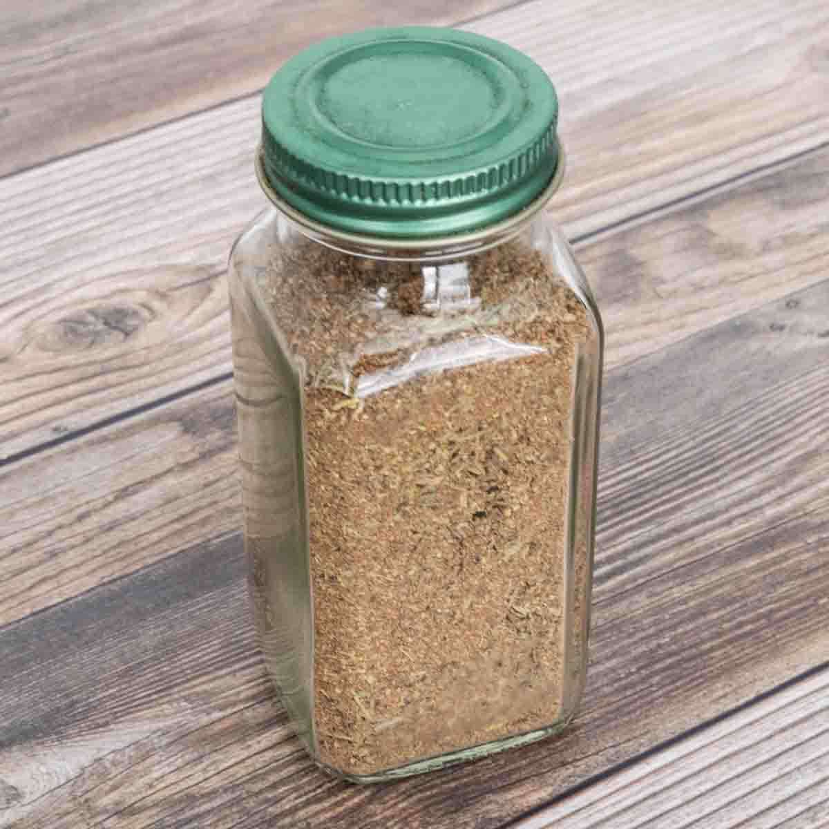Poultry seasoning in a glass jar with a green lid.