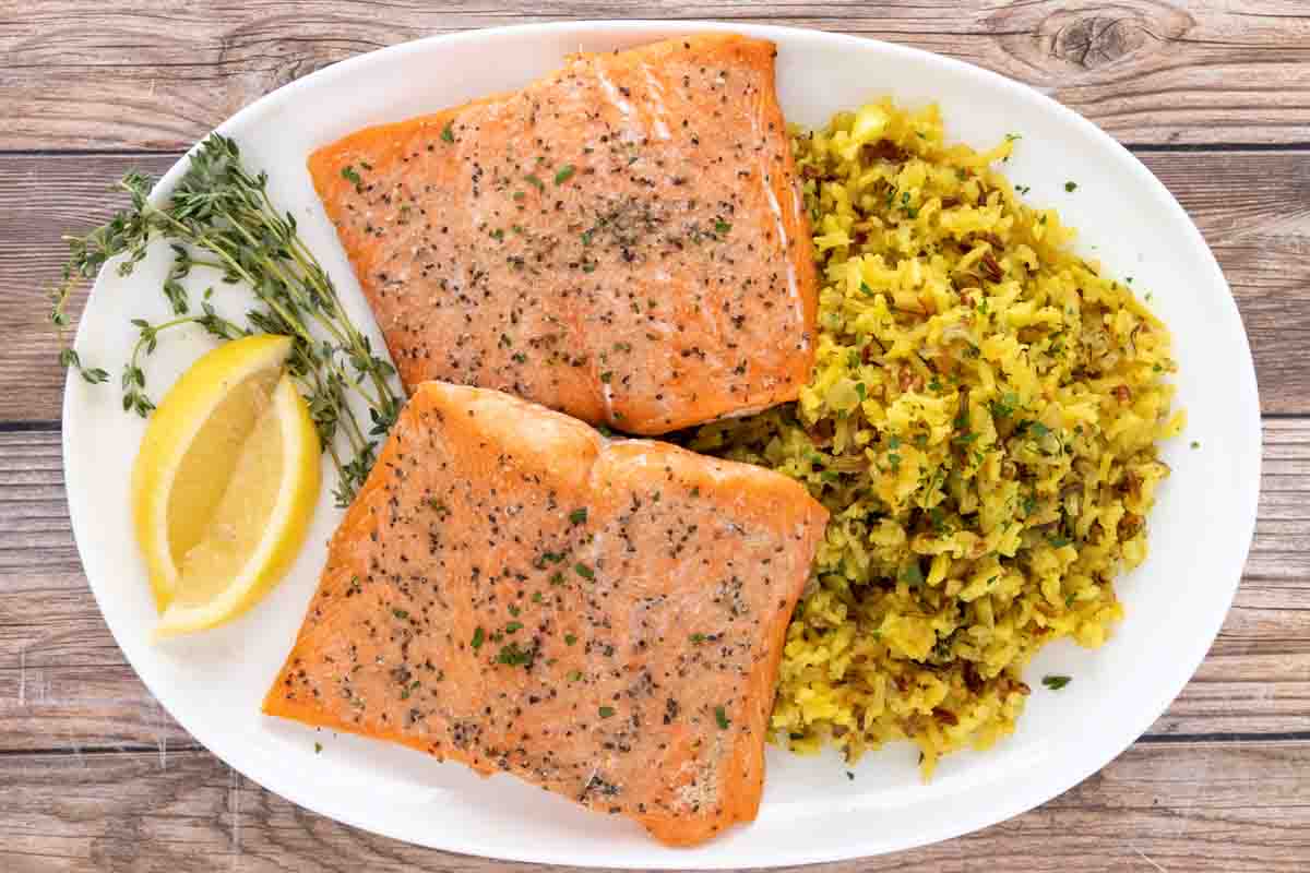 baked salmon and rice on a white platter