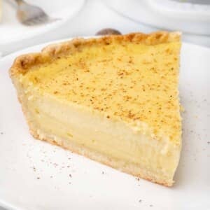 Slice of egg custard pie on a white plate