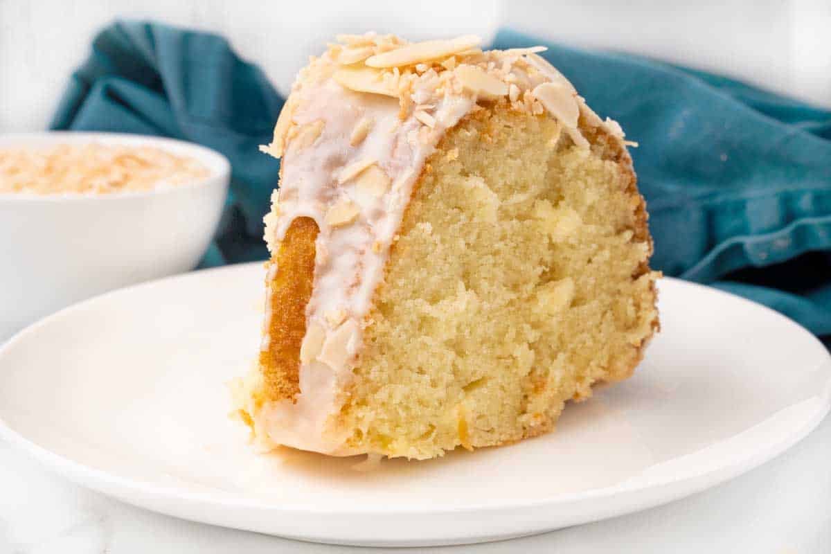 Slice of Louisiana crunch cake on a white plate.