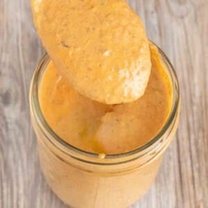 Chipotle pepper sauce in mason jar with spoon coming ut of the jar.