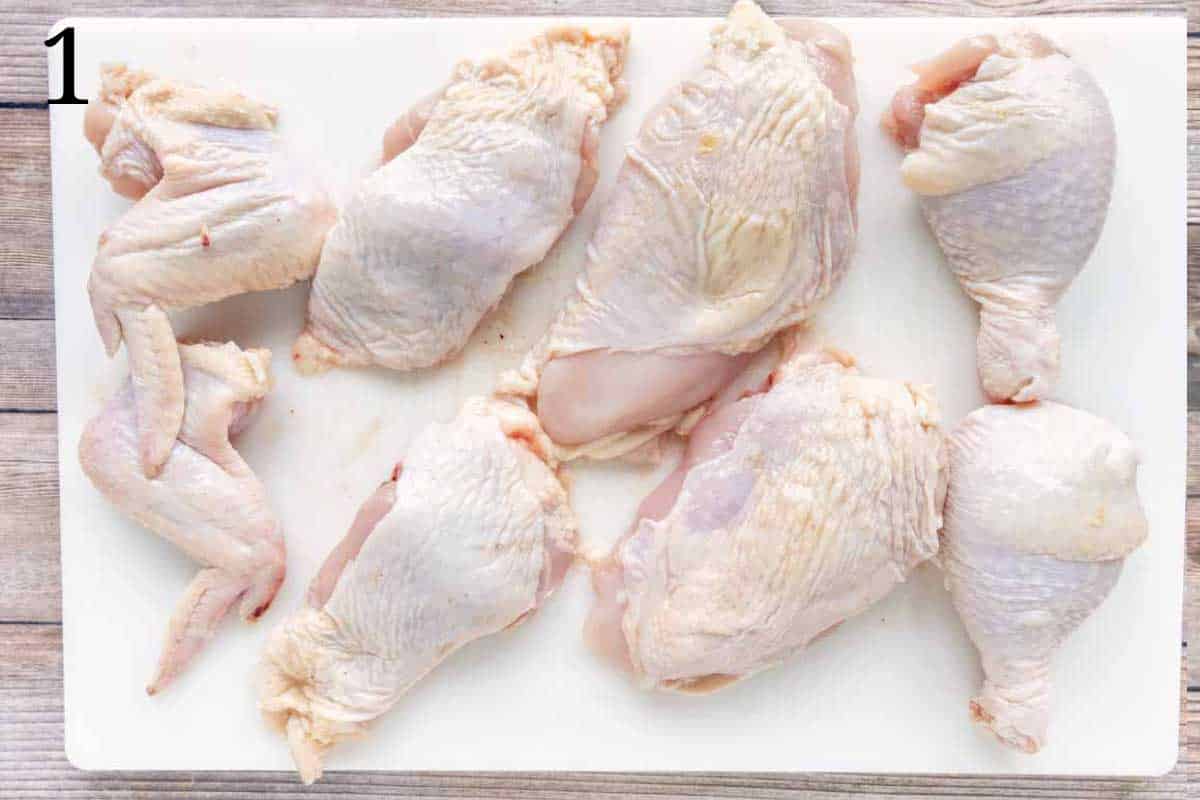 Cut chicken on a white cutting board.