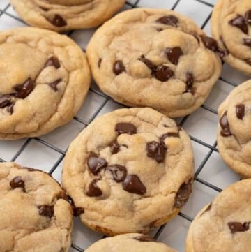 Chocolate chip cookies on a wire rack.