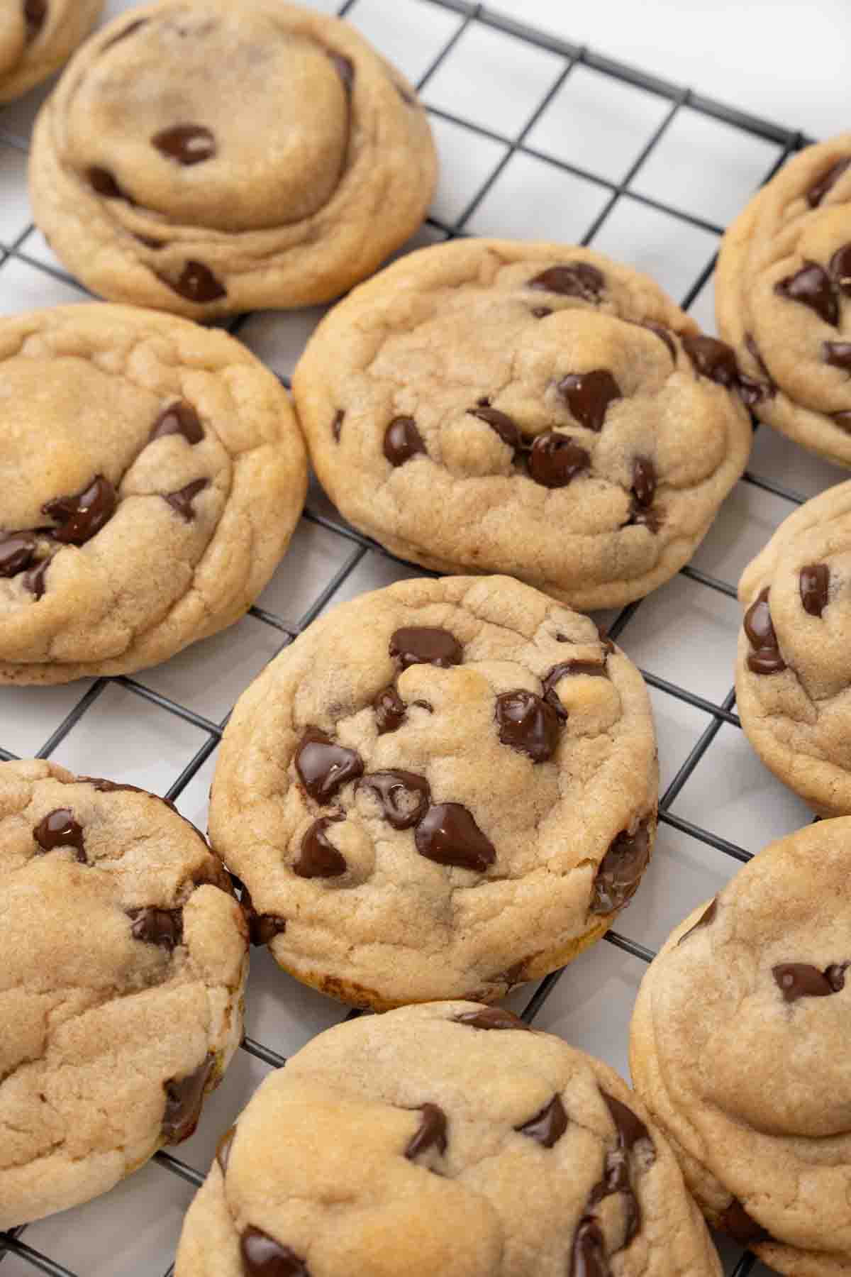 Chocolate chip cookies on a wire rack.