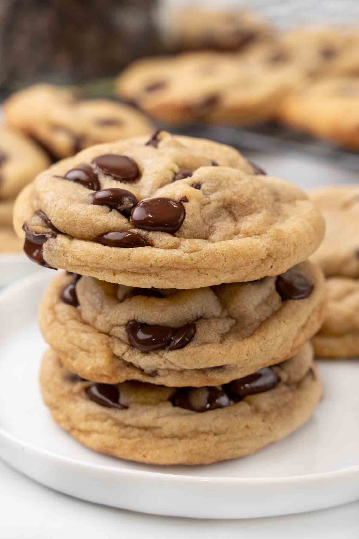 Chocolate chip cookies on a white plate.