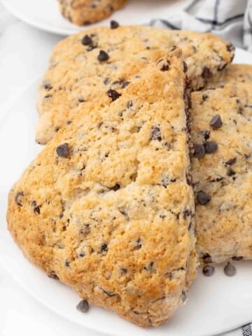 Chocolate chip scones on a white plate.
