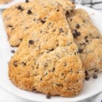 Chocolate chip scones on a white plate.
