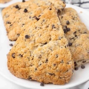 Chocolate chip scones on a white plate.