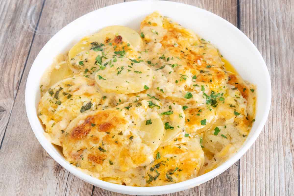 Potatoes au Gratin in a white bowl.