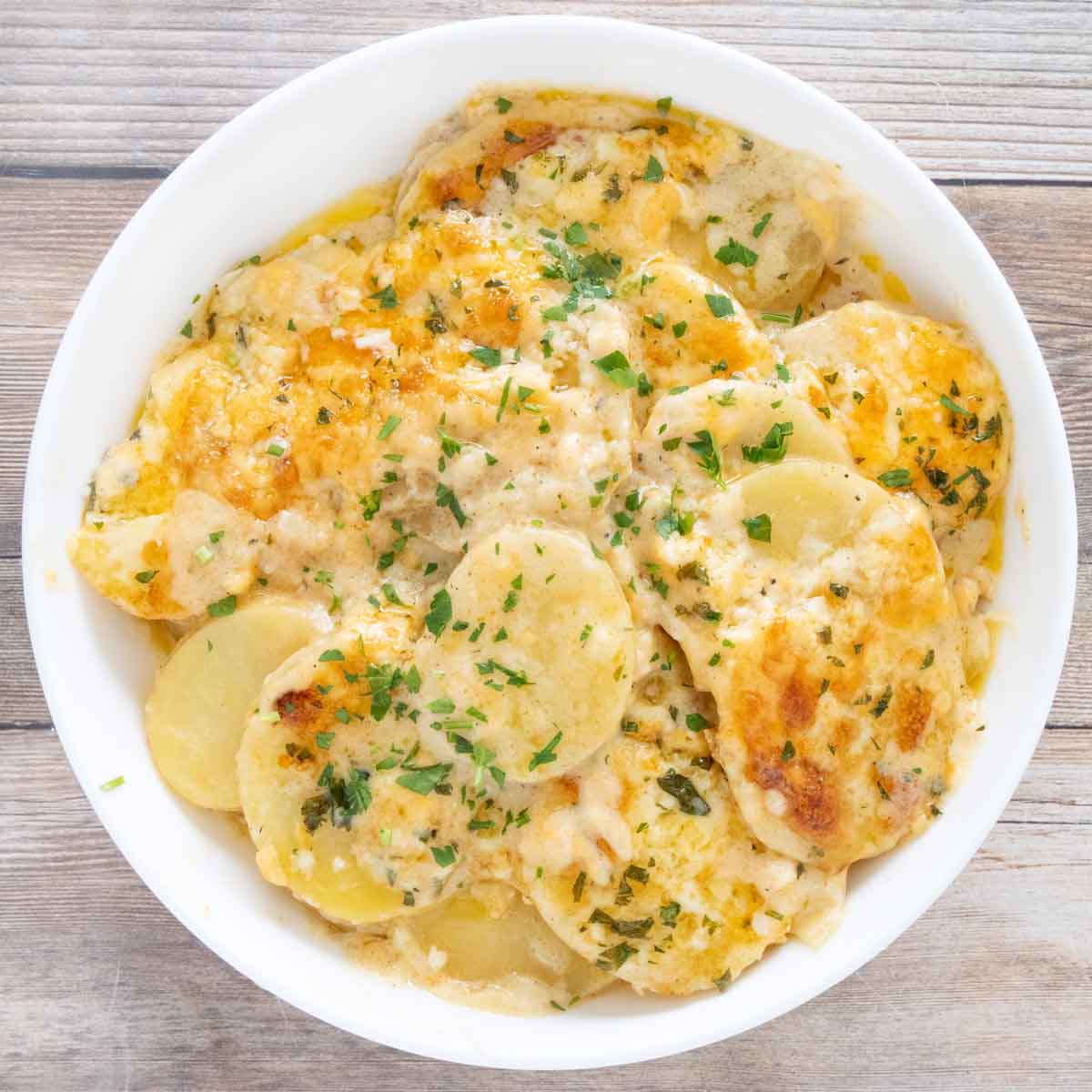 Potatoes au Gratin in a white bowl.