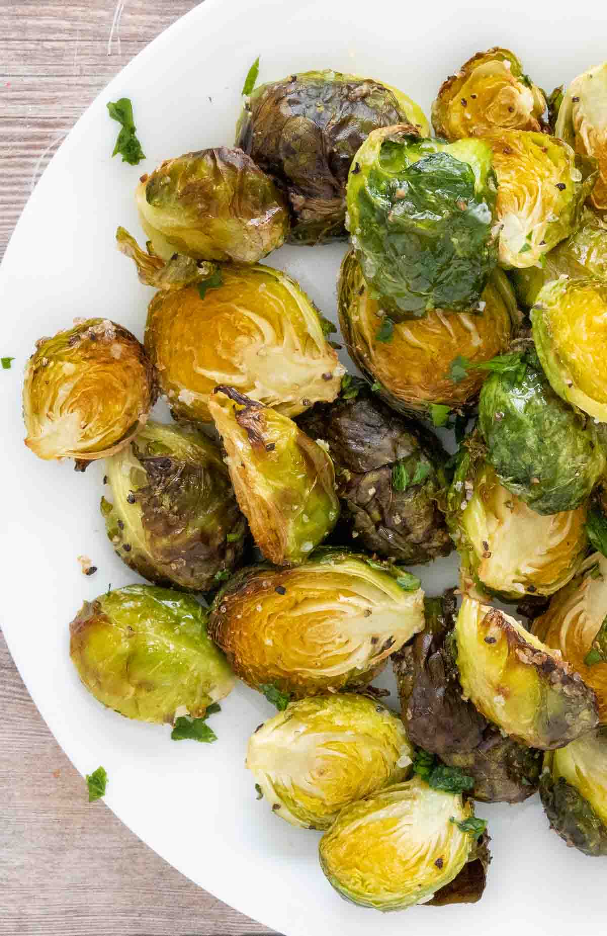 roasted brussels sprouts on a white plate.