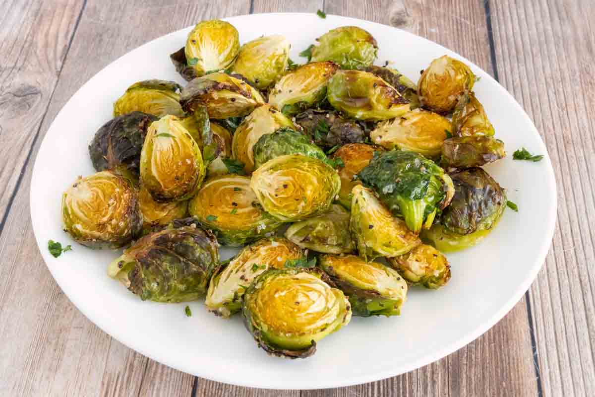 roasted brussels sprouts on a white plate.