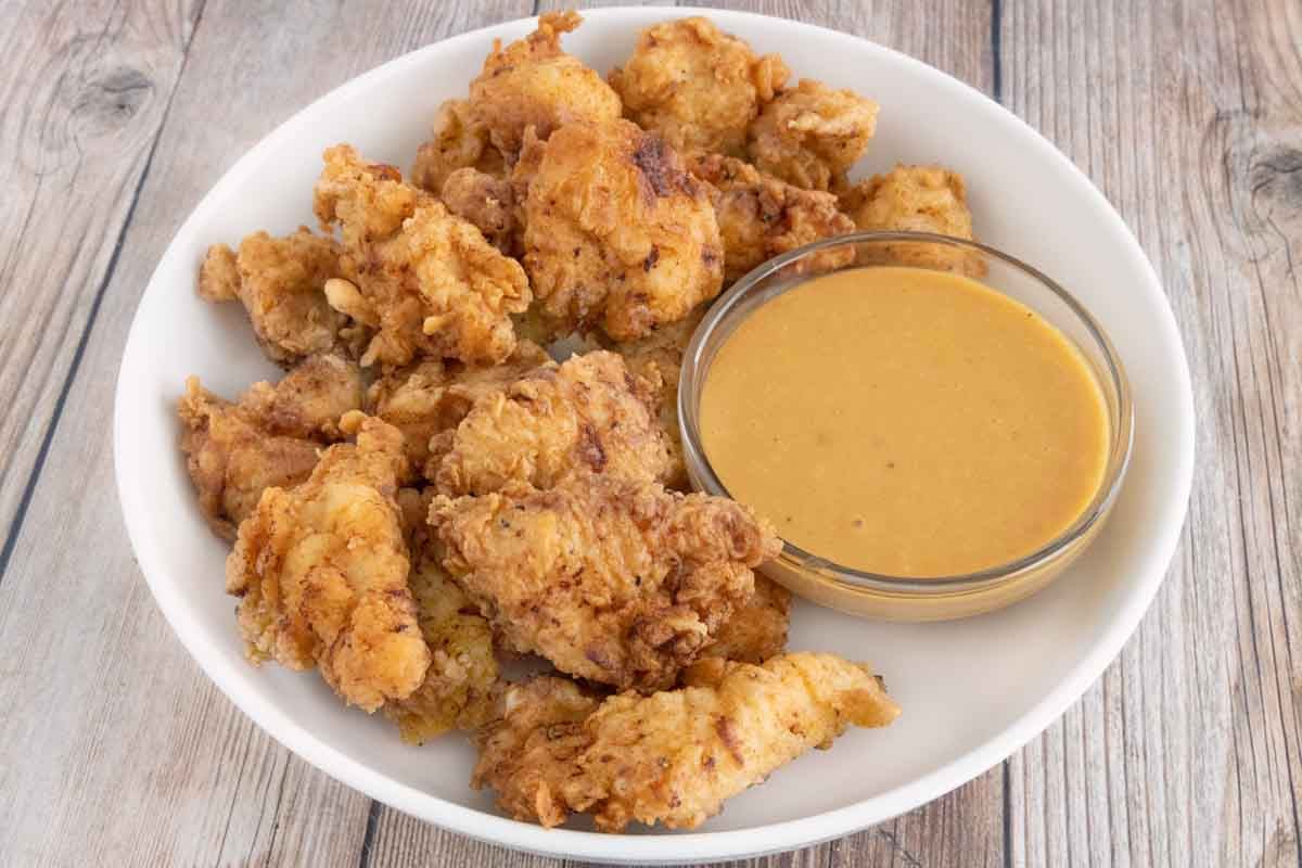 Chick-fil-A sauce with chicken nuggets in a white serving bowl.