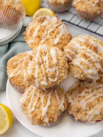 Lemon streusel muffins on white platter.