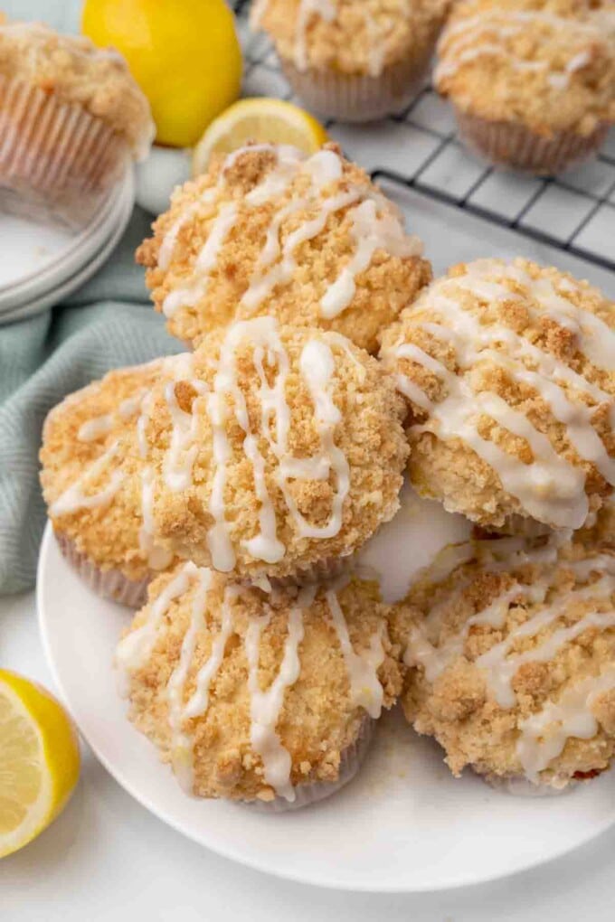 Lemon streusel muffins on white platter.