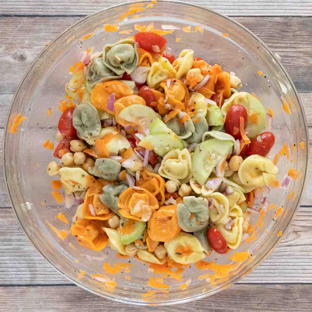 Finished pasta salad in a glass bowl.