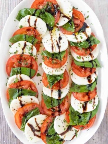 Caprese salad on a white platter.