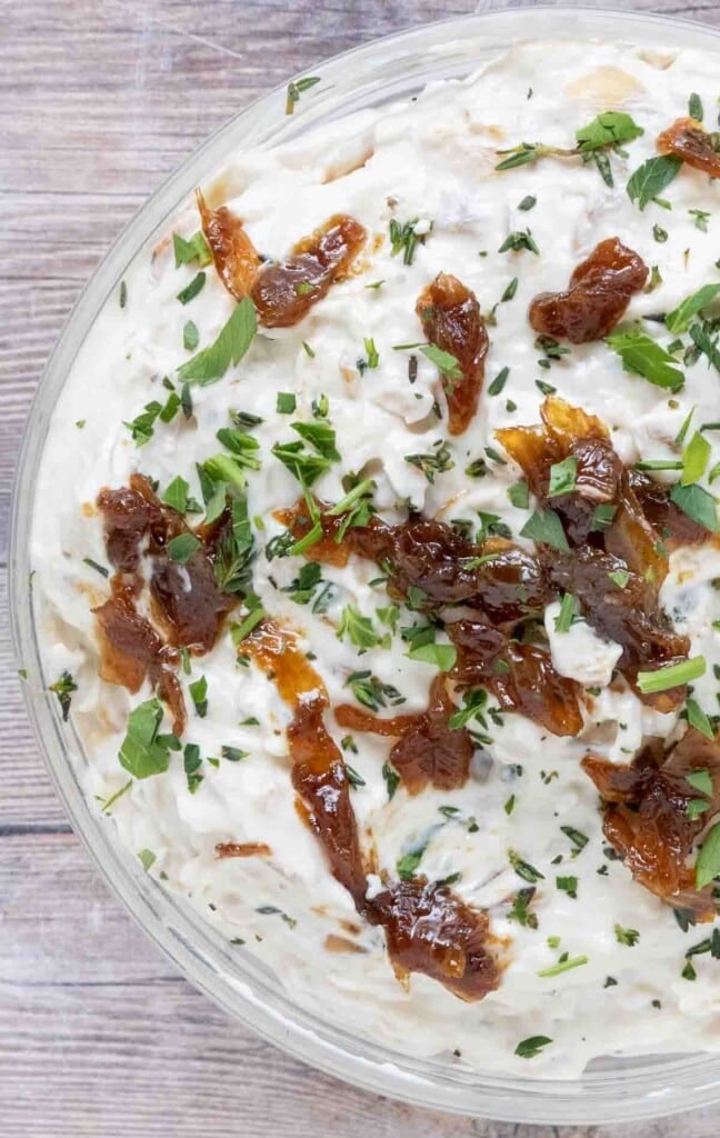 French onion dip in a glass bowl.