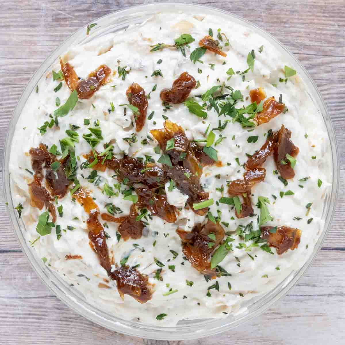 French onion dip in a glass bowl.