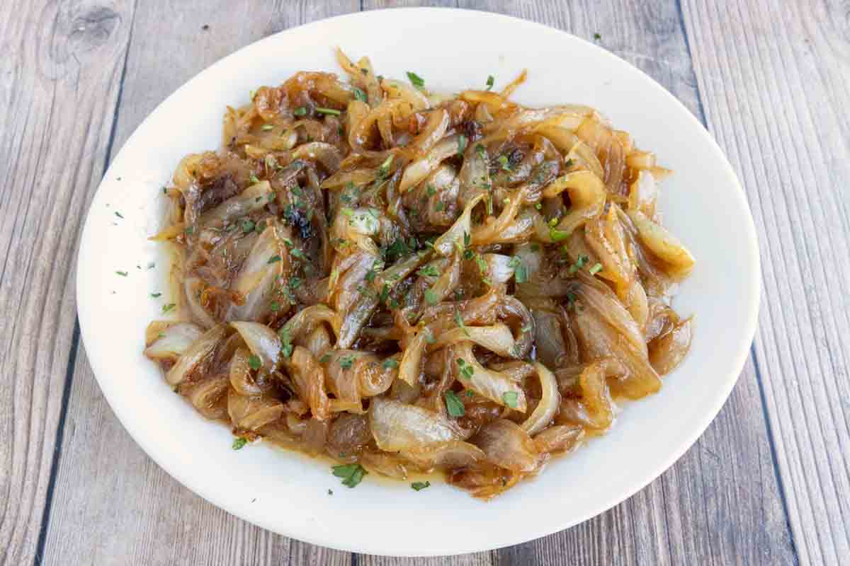 Caramelized onions in a white bowl.