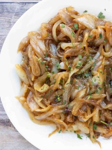 Caramelized onions in a white bowl.