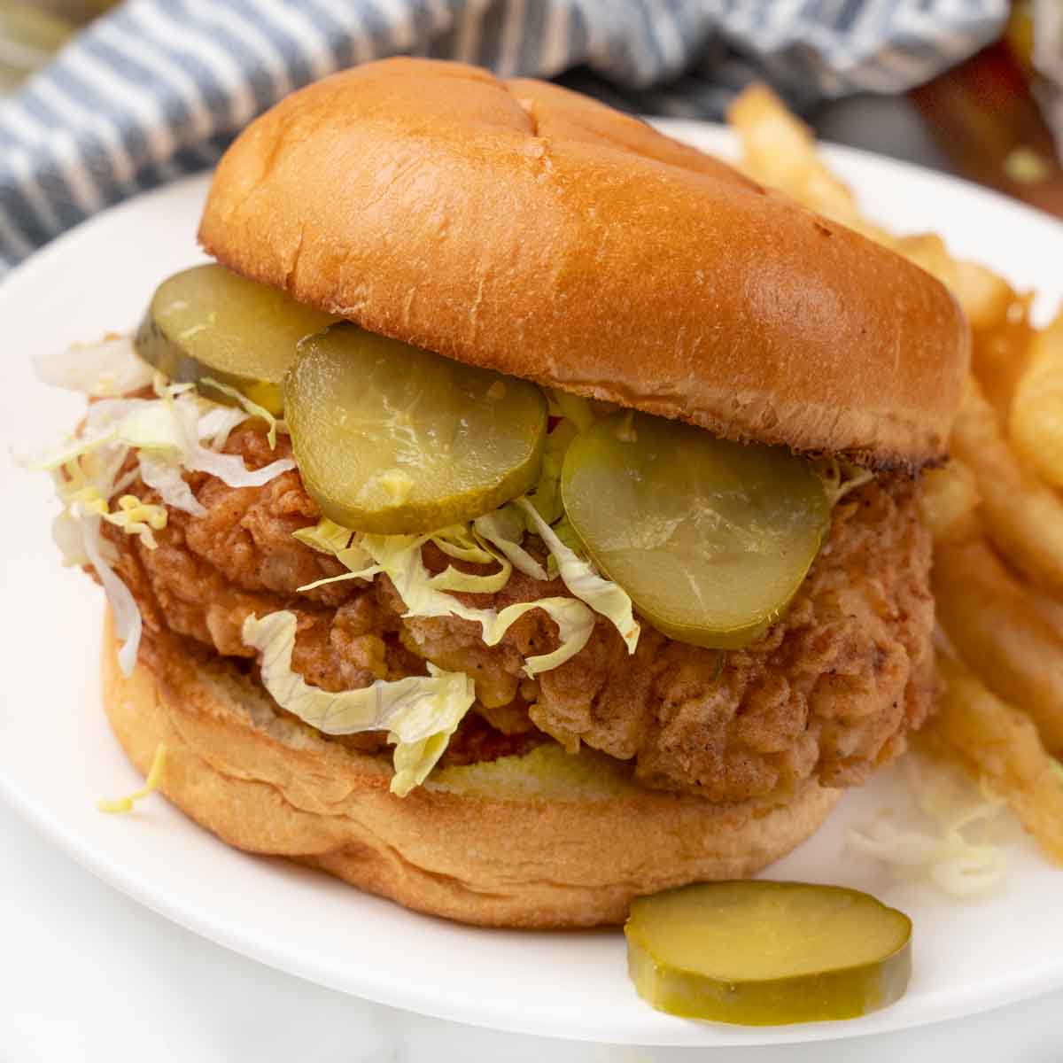Fried chicken sandwich on a white plate.