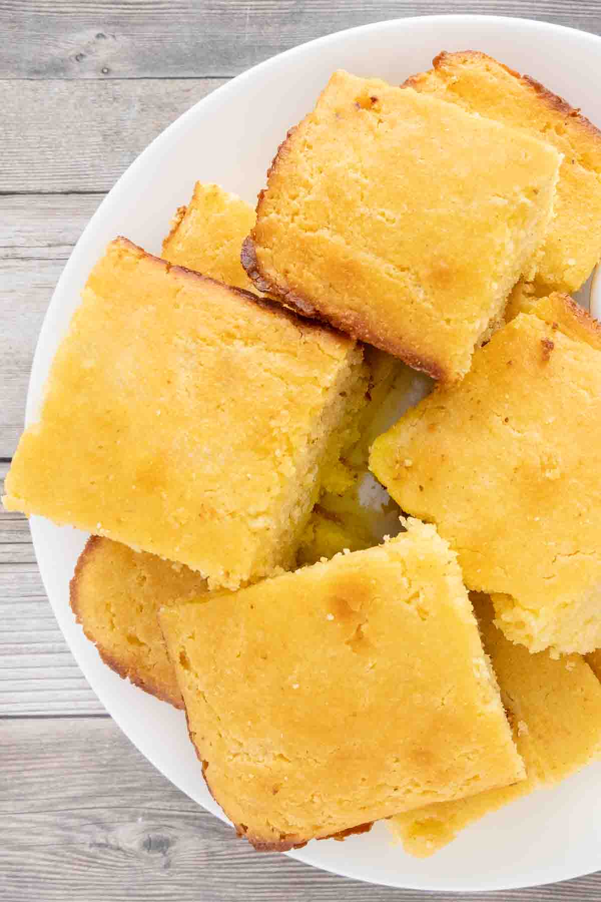 Cornbread stacked on white platter.