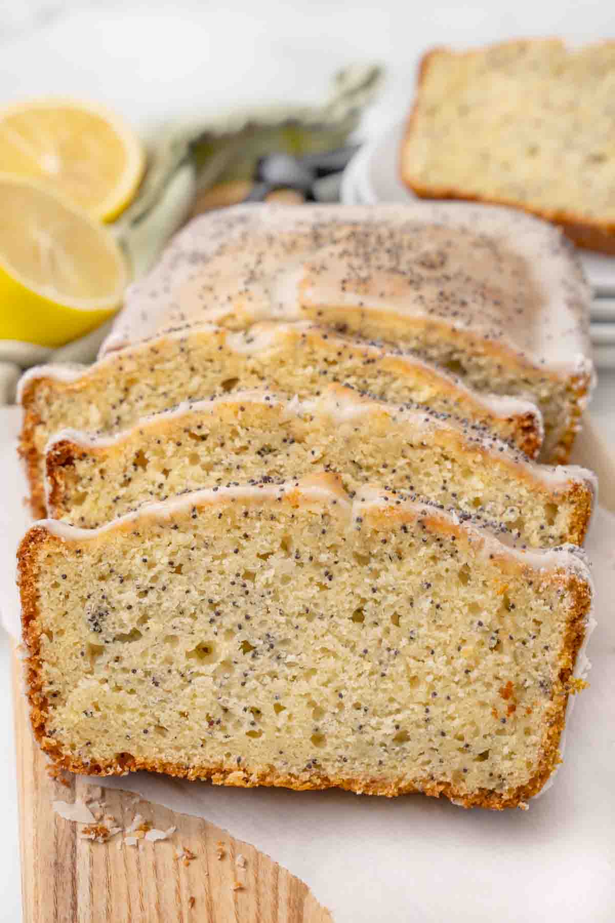 Slices of lemon poppy seed cake on a white platter.