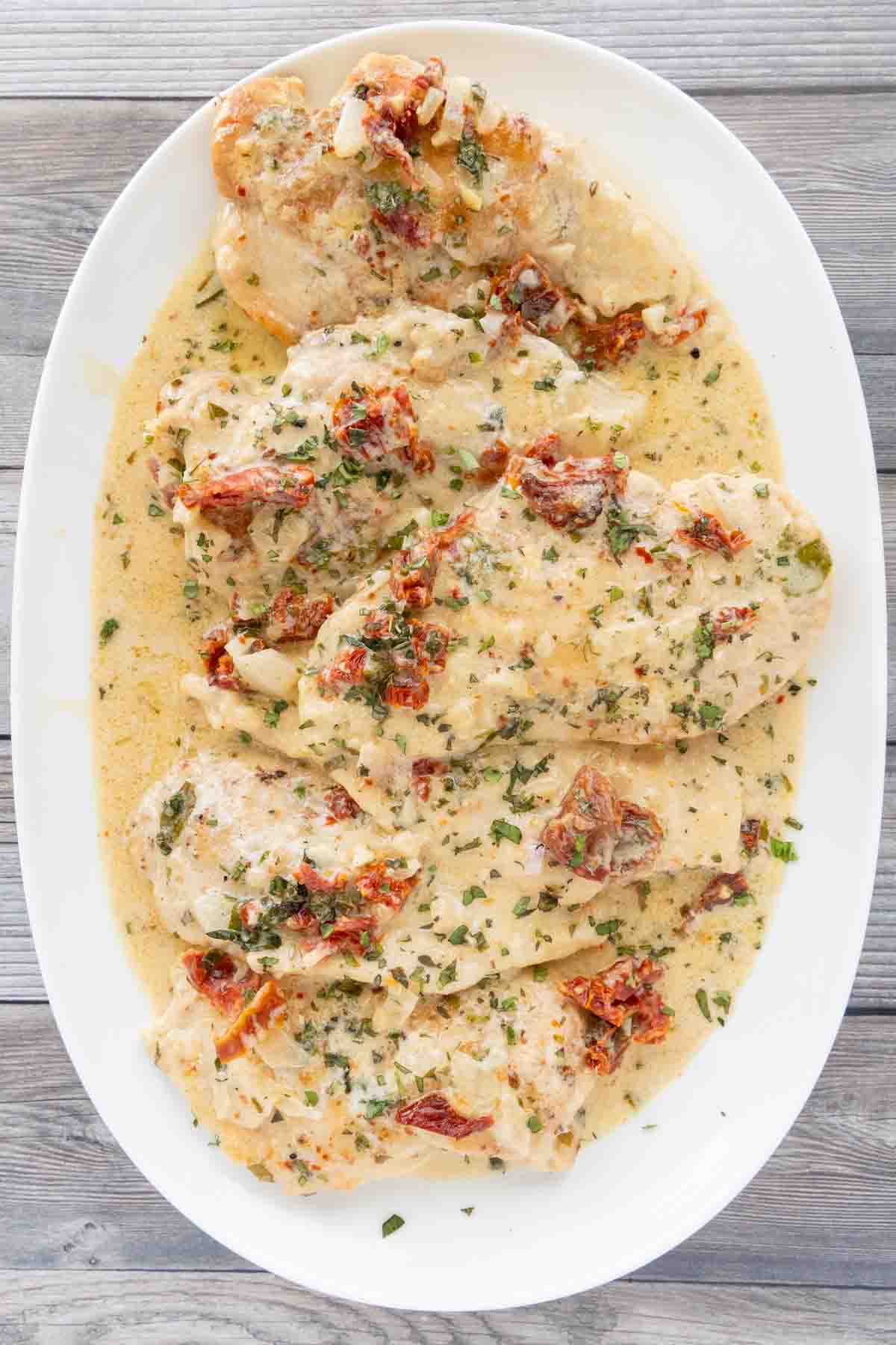 Marry me chicken on a white platter.