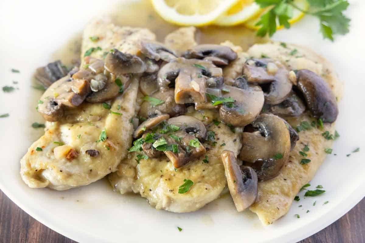 Chicken scallopini on a white plate.