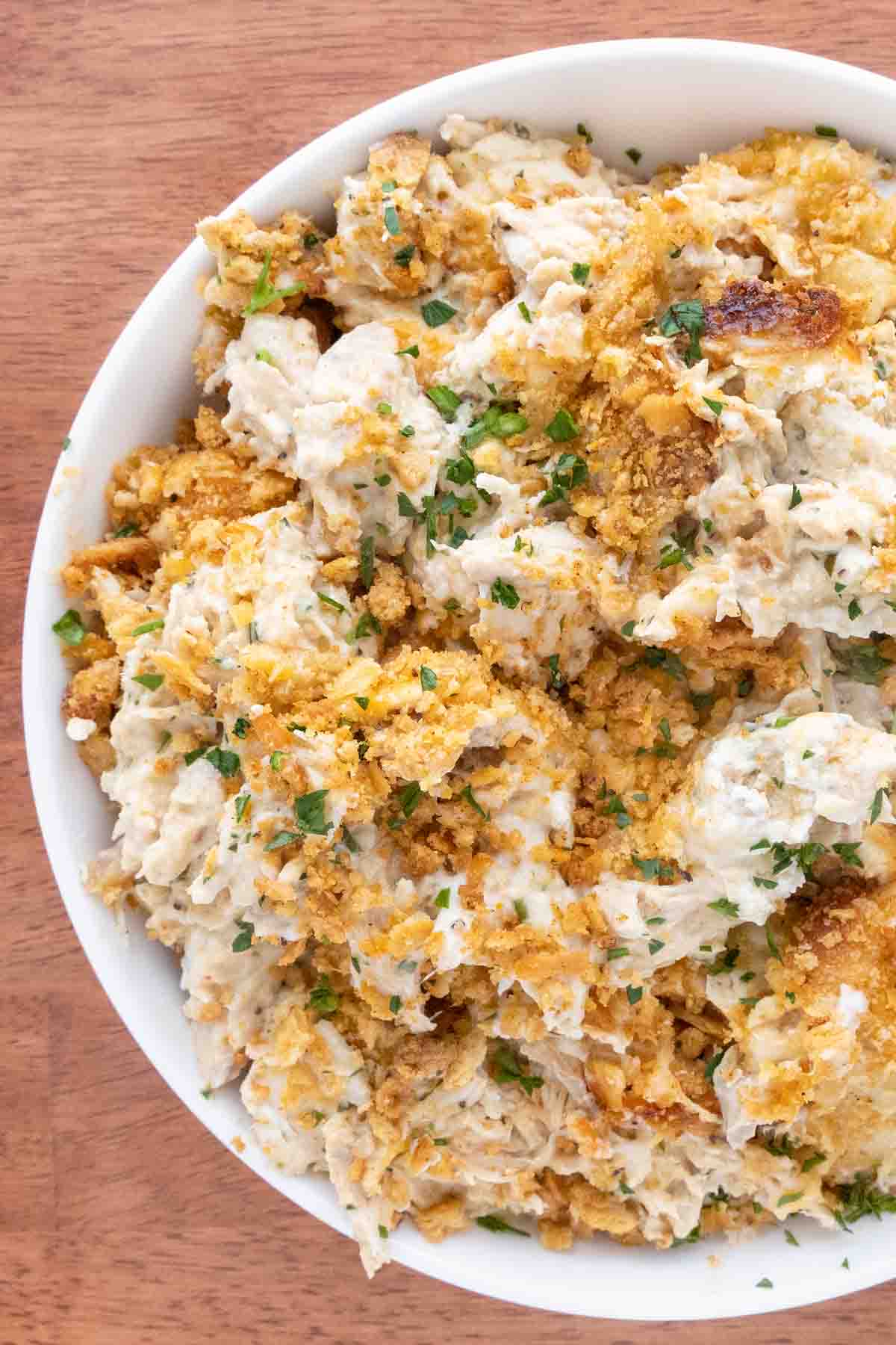 Million dollar chicken casserole in a white bowl.