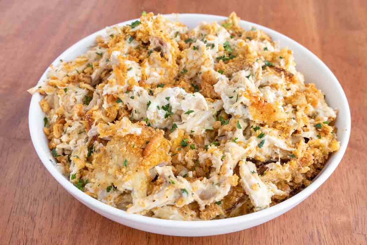 Million dollar chicken casserole in a white bowl.