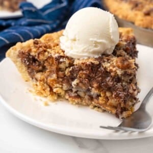 Slice of Texas trash pie on a white plate with a fork.
