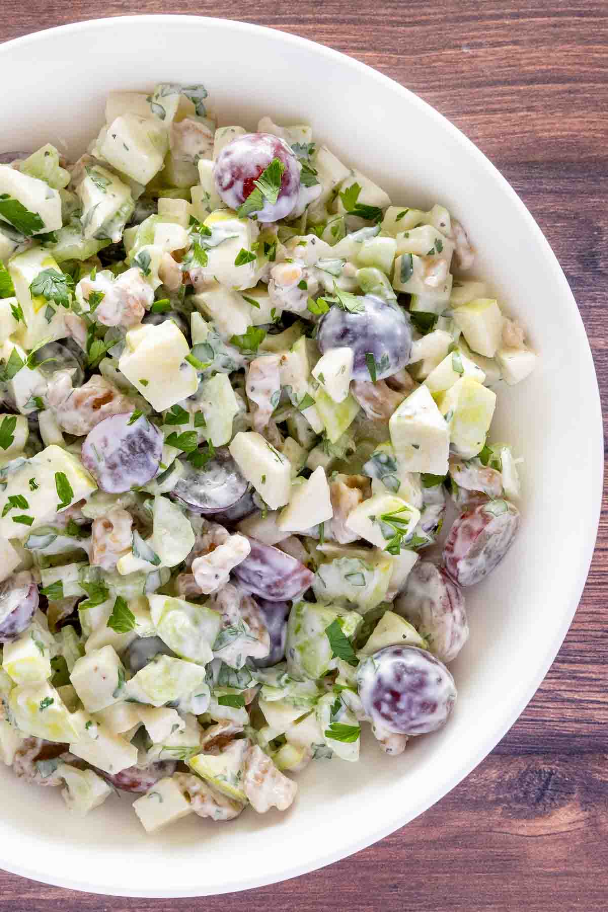 Waldorf salad in a white bowl.