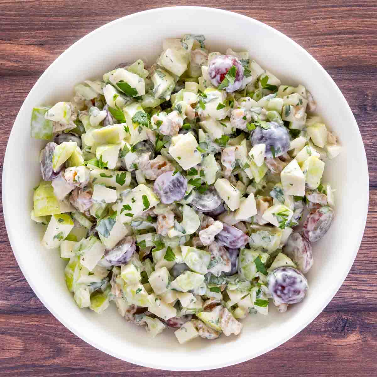 Waldorf salad in a white bowl.