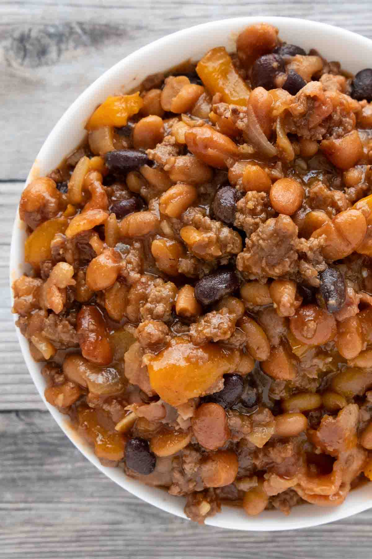 Cowboy beans in a white bowl.
