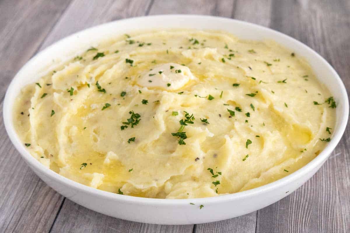 Garlic mashed potatoes in a white bowl.