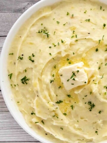 Garlic mashed potatoes in a white bowl.
